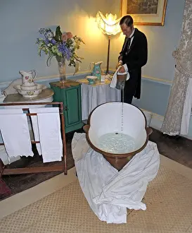 Victorian Prints: Victorian bath with butler pouring hot water in a tiled en-suite bathroom