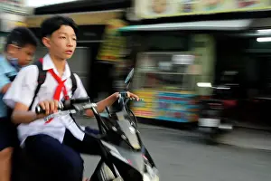 Saigon Prints: Vietnamese school boy on motorbike. Ho Chi Minh City. Vietnam