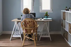Concentrate Prints: Back view of adult woman in casual clothes working on laptop in earphones at room decorated with cactuses in ceramic