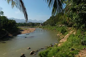 South East Asia Prints: View of a bamboo bridge over the Nam Khan River in Luang Prabang in Central Laos