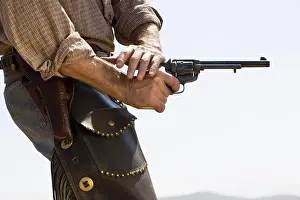 Macho Prints: Side view of a cowboy shooting a gun