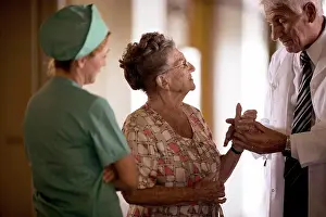 Communications Prints: View of a doctor checking up an elderly woman