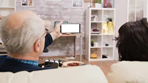 Video Prints: Back view of elderly age couple looking at phone with green screen