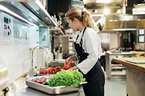 Vegetables Prints: Side view female chef washing vegetables kitchen