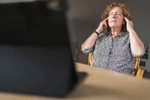 Home Prints: Side view of focused adult woman in casual clothes enjoying music in earphones with closed eyes while resting during