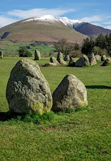 View looking from Castlerigg Stone Circle towards snow topped Blencathra in spring late winter