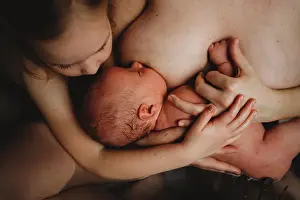 Gradeschooler Prints: Top view of newborn baby breastfeeding and older sister hugging him