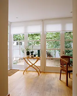 Doors Prints: View of patio through glass doors with white blinds in modern livingroom with small table on wooden floor