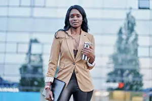 Attractive Prints: front view portrait of black woman wearing a brown suit talking on the phone