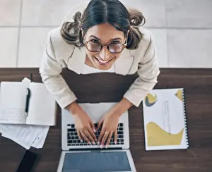 Financial Prints: Top view, portrait or business woman on laptop in company finance management
