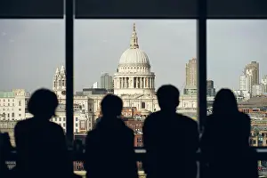Anonymous Prints: Back view silhouettes of travelers standing near window at viewpoint