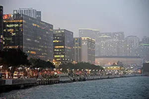 Luminous Prints: View of skyscrapers and Victoria Harbour in the evening