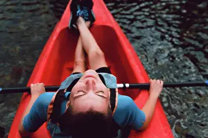 Recreation Prints: Back view of sportswoman sitting in red canoe and raising paddle on Sella river decline in Spain