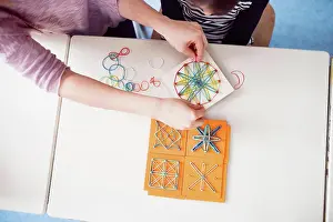 Mathematics Prints: Top view of teacher using geoboard in class