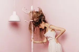 Expressive Prints: Front view of a teenage girl with tangled hairs on pink background