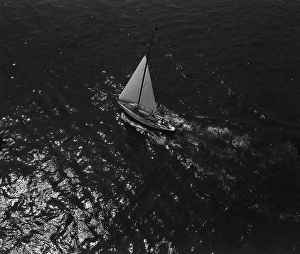 Sailboat Prints: Vintage Photograph. Aerial view of sailboat sailing in the moonlight