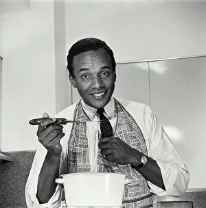 Apron Prints: Vintage Photograph. African American man in apron making dinner