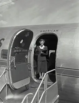 Doorway Prints: Vintage photograph. American airlines stewardess standing in plane doorway