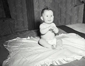 Newborn Prints: Vintage photograph. Baby sitting on blanket