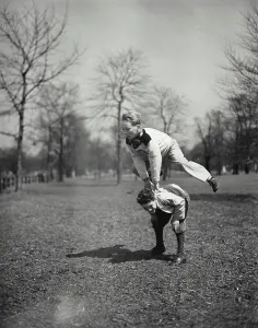 Frog Prints: Vintage photograph. Boys playing leap frog