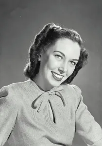 Sweater Prints: Vintage photograph. Brunette woman wearing sweater blouse with tie on collar smiling looking up