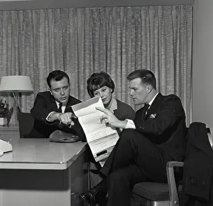 Analysis Prints: Vintage Photograph. A businessman and a couple sitting at a desk reviewing a credit contract