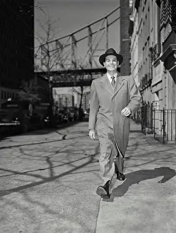 Pavement Prints: Vintage photograph. Businessman in long jacket and suit walking on sidewalk