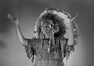 Feather Prints: Vintage Photograph. Caucasian man in Native American head dress. Frame 4