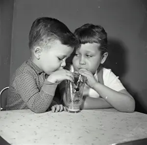 4 5 Years Prints: Vintage Photograph. Close-up of a boy and his sister sharing a glass of juice