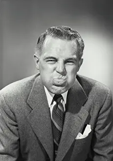 Sticking Out Tongue Prints: Vintage photograph. Close-up of a businessman blowing raspberry