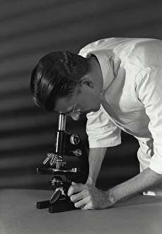 40 45 Prints: Vintage Photograph. Close-up of a scientist looking through a microscope
