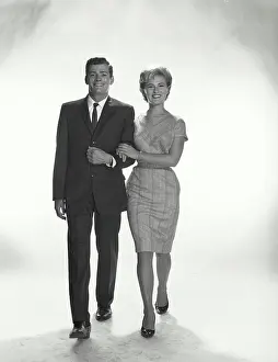 Classy Prints: Vintage Photograph. A couple with linked arms walking and smiling in studio