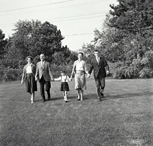 Skirts Prints: Vintage Photograph. Family walking together in backyard