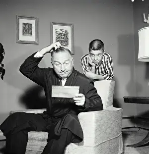 Childs Prints: Vintage Photograph. Father scratches his head as he looks at childs report card who stands behind him