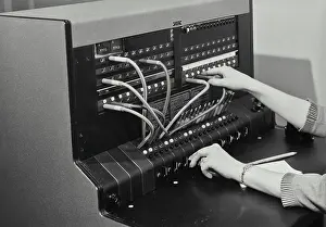Network Prints: Vintage Photograph. Female hands operating telephone switchboard