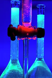 Contrast Prints: Vintage Photograph. Futuristic glowing chemistry experiment with vibrant neon liquids in lab glassware