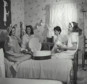 Curtain Prints: Vintage Photograph. A group of young girls at slumber party trying on floral hat