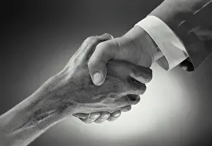 Deal Prints: Vintage Photograph. Hands of two men shaking in front of background with radial gradient light