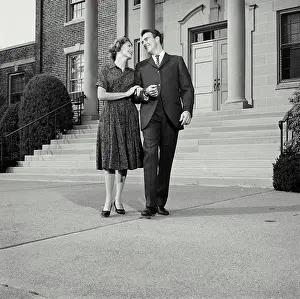 Vintage Photograph. Husband and wife walking down steps with arms locked. Frame 5