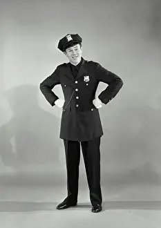 Arms Akimbo Prints: Vintage photograph. Full length portrait of policeman with hands on hips
