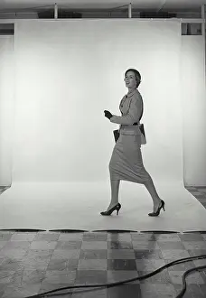 Skirt Prints: Vintage Photograph. Full length view of woman wearing light grey skirt and jacket and hat on white studio background
