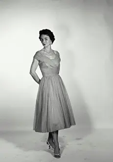 Graceful Prints: Vintage Photograph. Full length of a woman in a dress on white backdrop