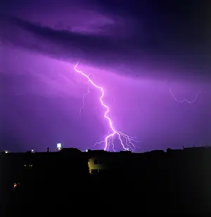 Flash Prints: Vintage Photograph. Lightning illuminates the night sky with a vibrant purple hue