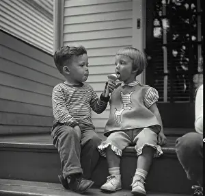 4 5 Years Prints: Vintage Photograph. Little boy sharing his ice cream cone with little girl. Frame 1