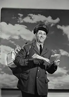 Carry Prints: Vintage Photograph. Mailman holding bag of mail and a letter. Frame 2