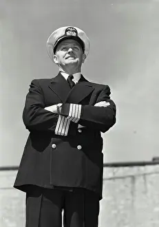 Sailor Prints: Vintage Photograph. Man in captains uniform standing with arms crossed and smiling