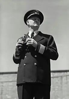 Sailor Prints: Vintage Photograph. Man in captains uniform standing with set of binoculars