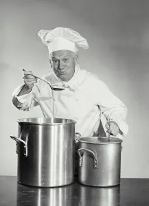 Chef Prints: Vintage photograph. man in chef uniform cooking in pot