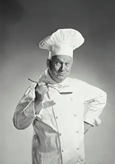 Uniform Prints: Vintage photograph. man in chef uniform tasting spoon