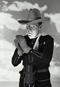 Smoking Prints: Vintage Photograph. Man in cowboy outfit with hat and gloves smoking cigarette